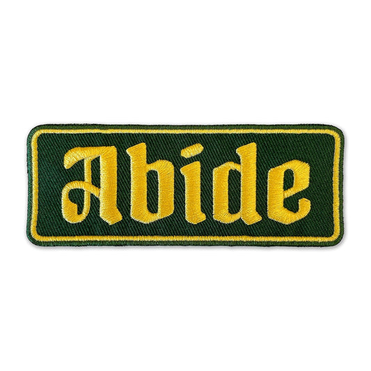 ABIDE Embroidered Patch - Iron-On Patch 4" x 1.5" - Green & Gold Gothic Font Great for Trucker Hats