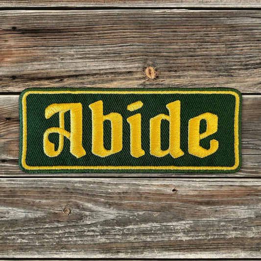 ABIDE Embroidered Patch - Iron-On Patch 4" x 1.5" - Green & Gold Gothic Font Great for Trucker Hats